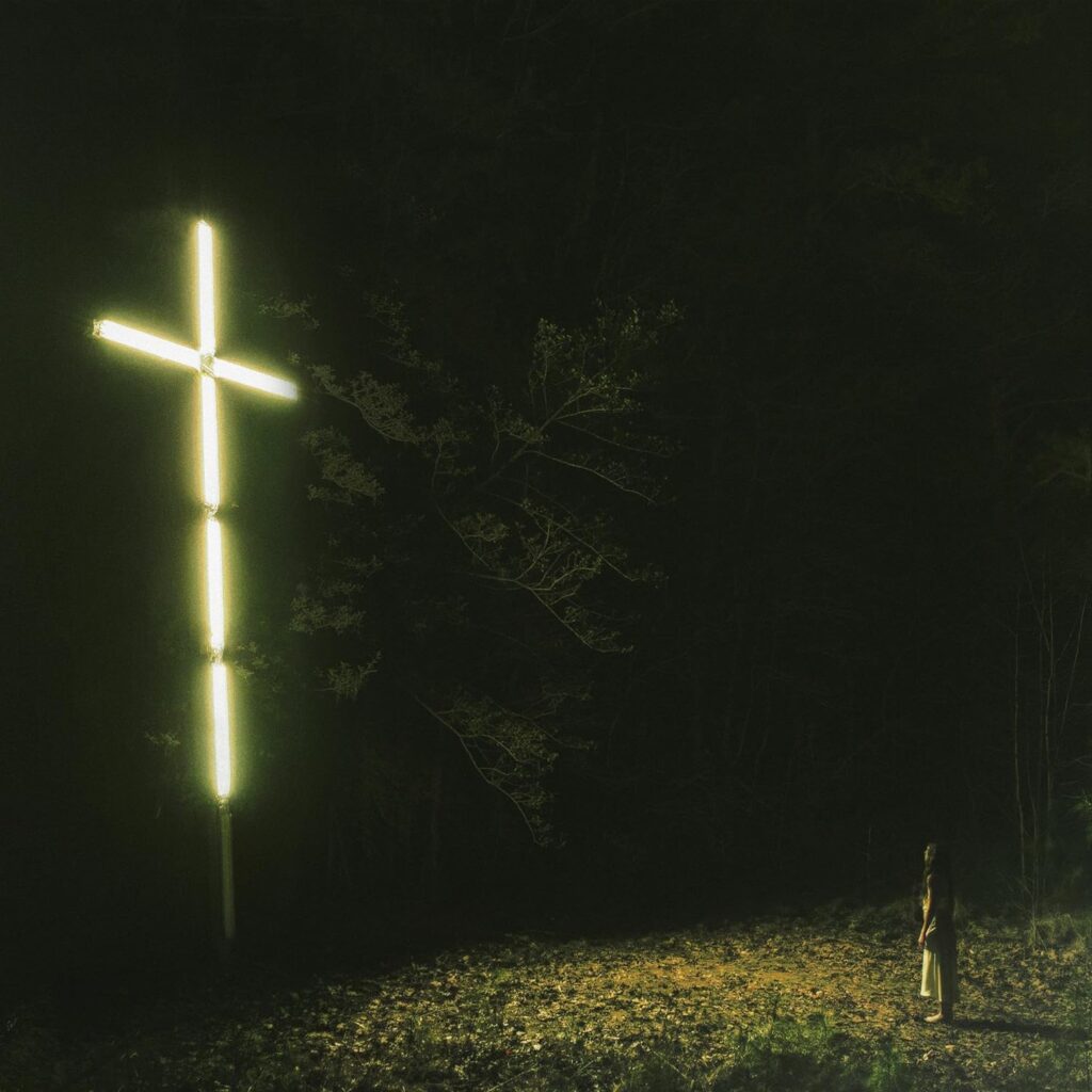 Album cover, a cross made of white light, in a night picture